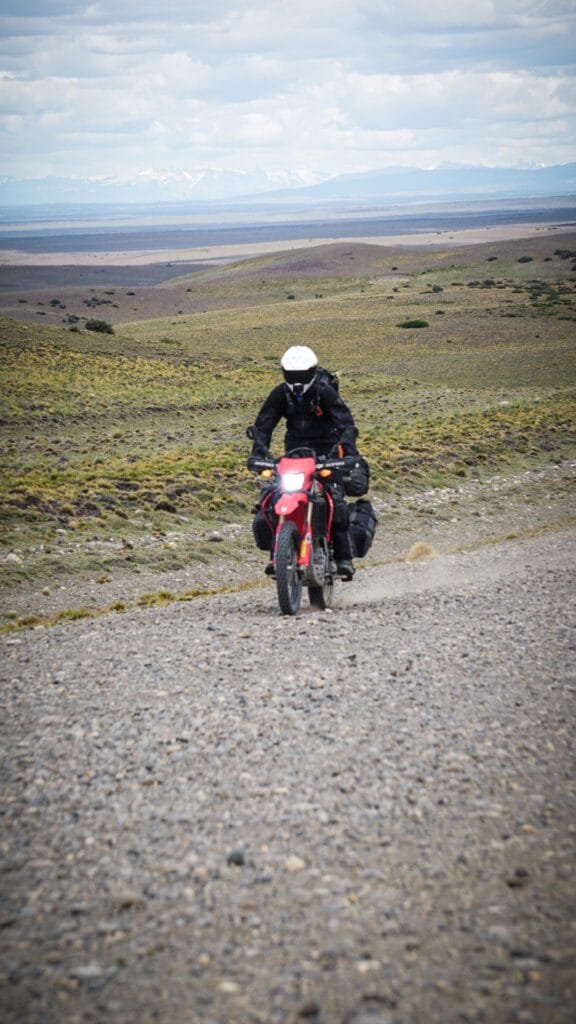 Red Honda CRF250L on a remote gravel road in Patagonia